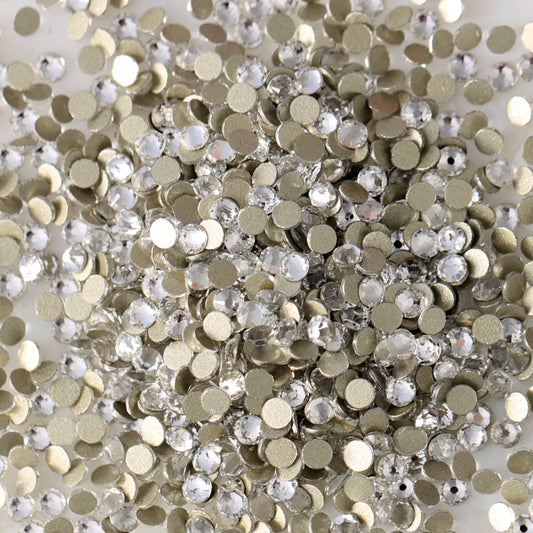 Clear flatback rhinestones with a 16-facet (8+8) cut and metallic foil backs forming a sparkling pile.