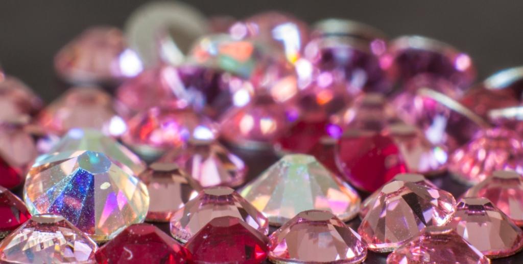 Close-up of colorful Eunails flatback round rhinestones in special effect shades, showcasing their brilliant sparkle and unique colors for nail art, crafts and fashion embellishments