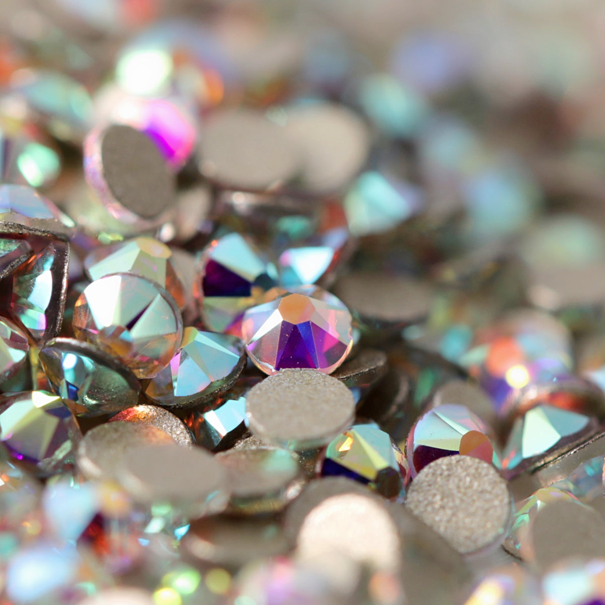 Flatback Crystal AB rhinestones with a 16-facet (8+8) cut and metallic foil backs scattered in a shimmering pile.