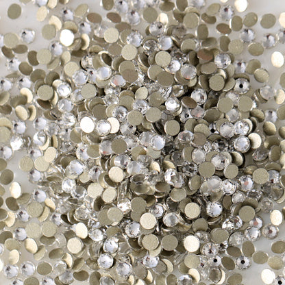 Clear flatback rhinestones with a 16-facet (8+8) cut and metallic foil backs forming a sparkling pile.