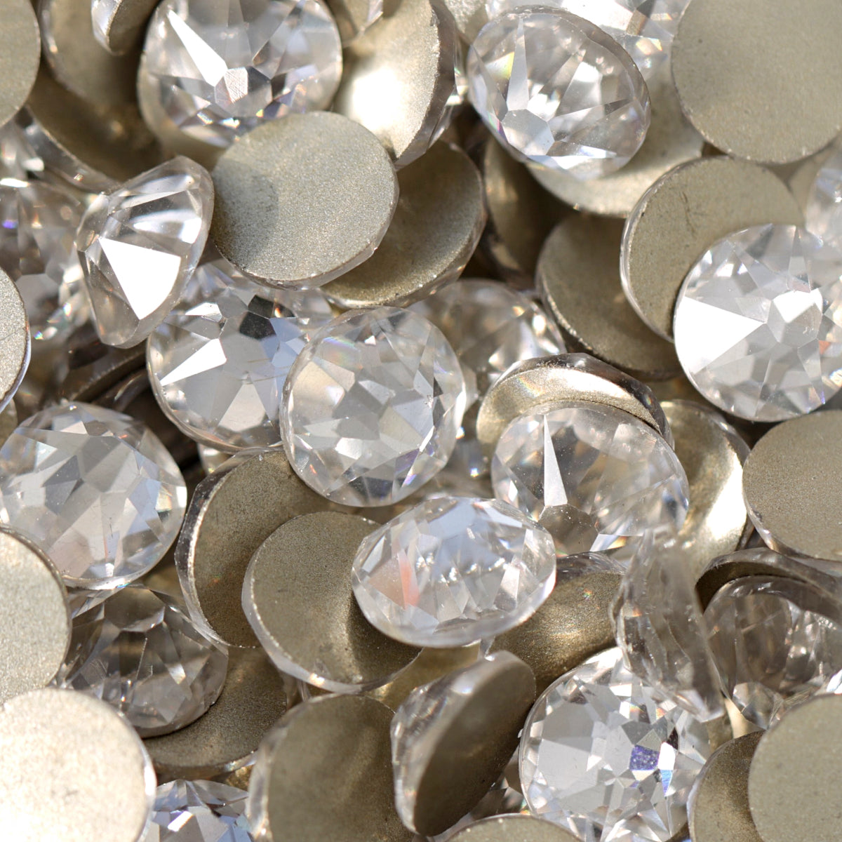 Clear flatback rhinestones with a 16-facet (8+8) cut and metallic foil backs forming a sparkling pile.