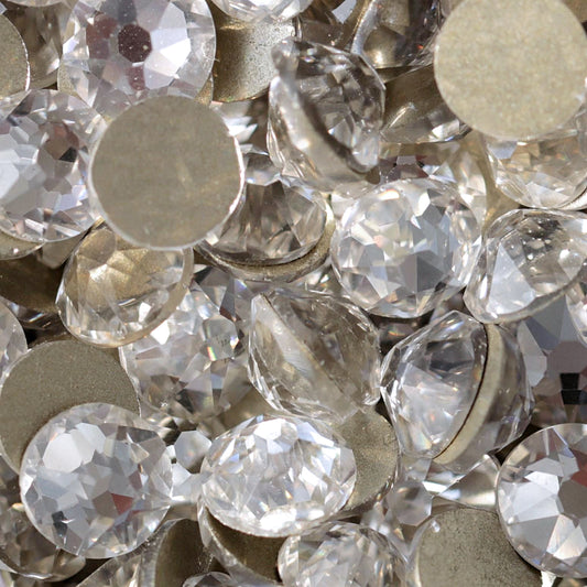 Clear flatback rhinestones with a 16-facet (8+8) cut and metallic foil backs forming a sparkling pile.