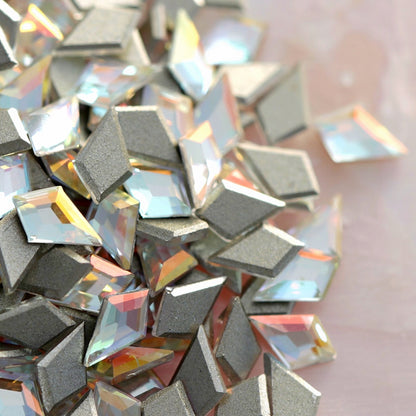 Close group of iridescent Crystal Gold Shimmer K9 flatback deltoid crystals highlighting multi-color light play and metallic silver backing for luxury crafts