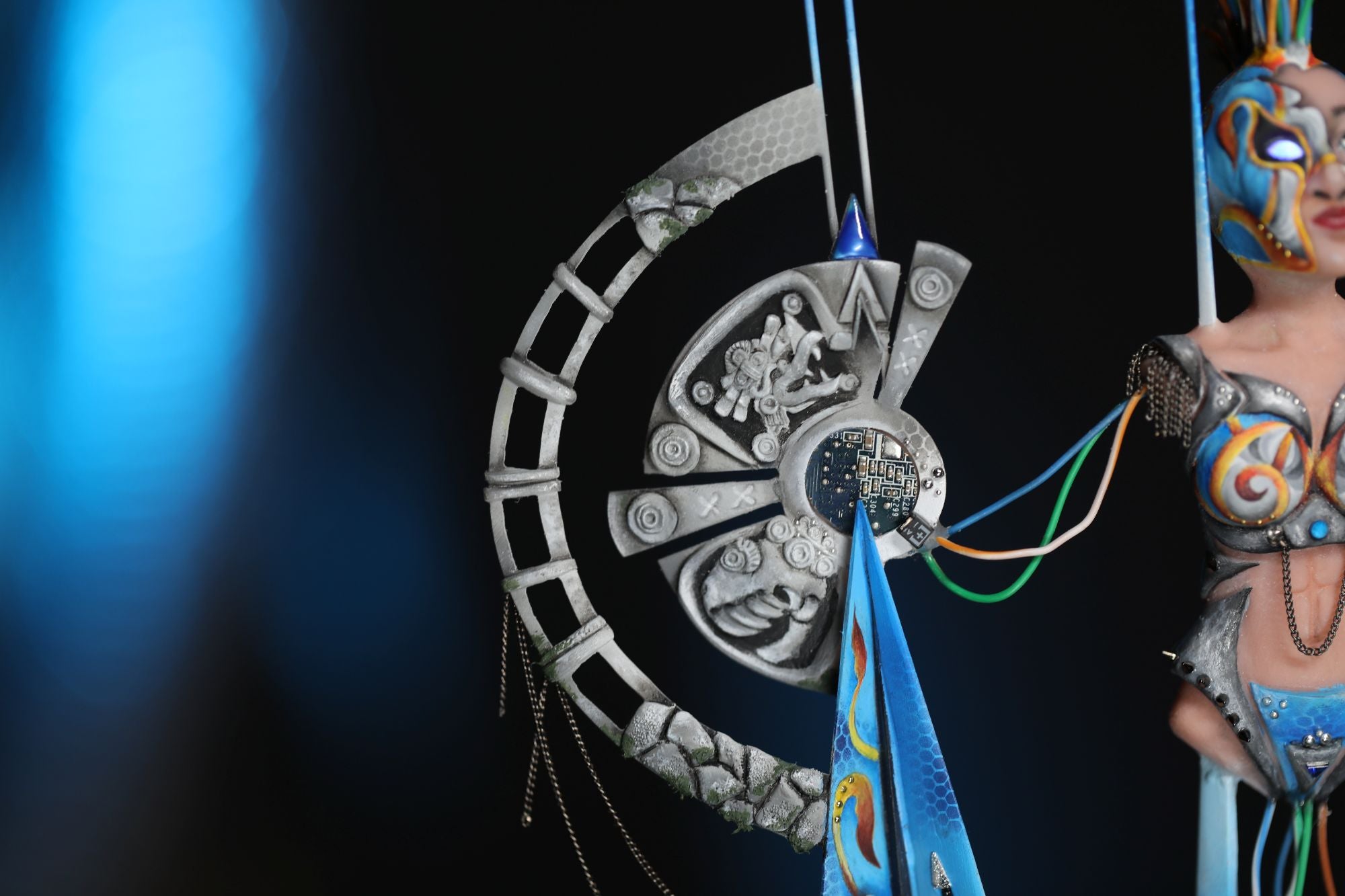 Editorial-style photo of a model with bold artistic makeup and extreme competition nails decorated with crystals, representing the creative nail art tutorials and inspiration on the Eunails Nail Art Blog