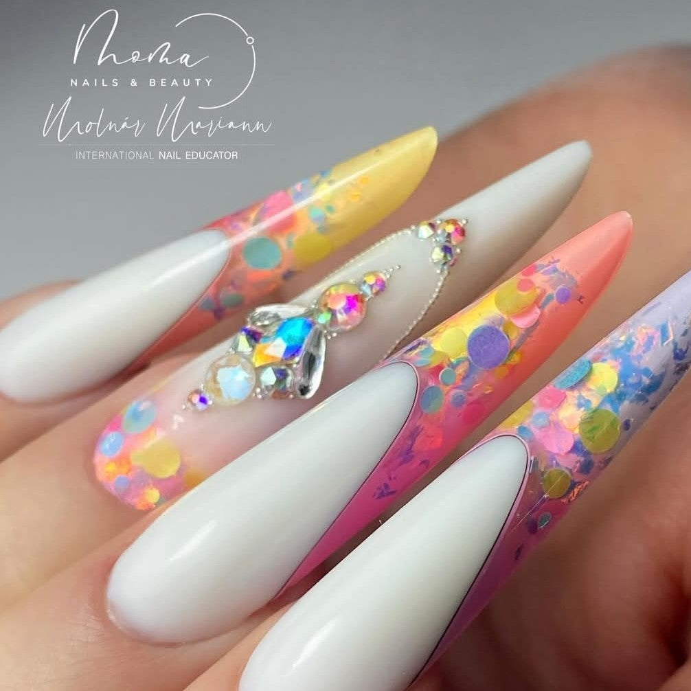 Model wearing elaborate rhinestone face makeup and jeweled long nails, demonstrating the creative cosmetic uses of Eunails rhinestones and nail art decorations.