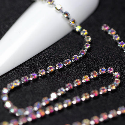 Close-up of silver 1.5 mm Crystal AB rhinestone cup chain for nail art on black background